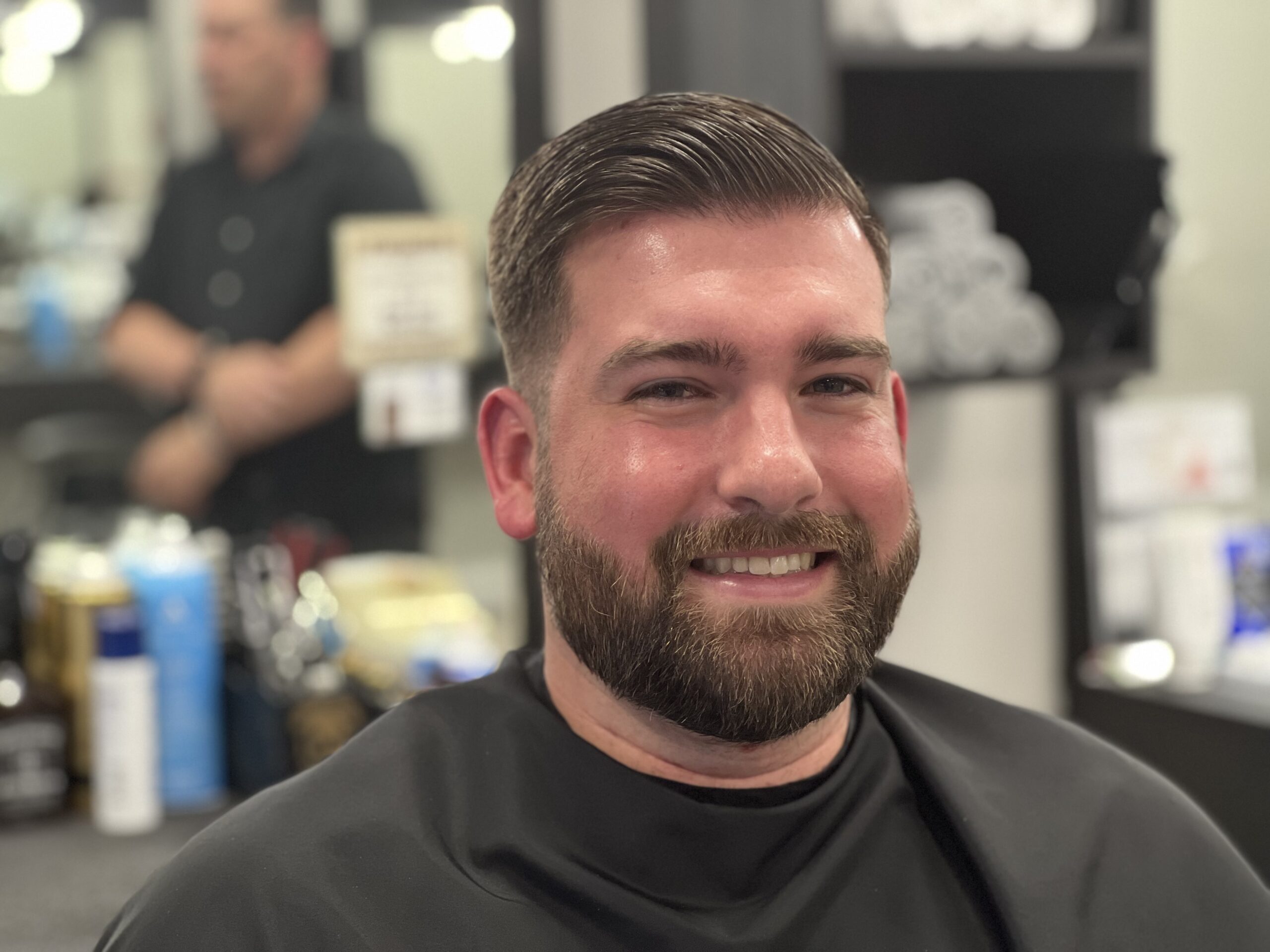 Man smiling after getting his hair cut
